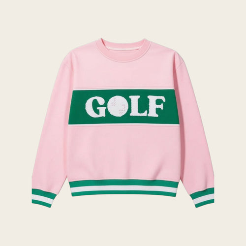 The Darling Effect Golf Signature Crew is a pink sweatshirt with green and white striped cuffs and hem, a green chest panel with bold white GOLF lettering, and soft fabric for comfort—an essential piece for any wardrobe.