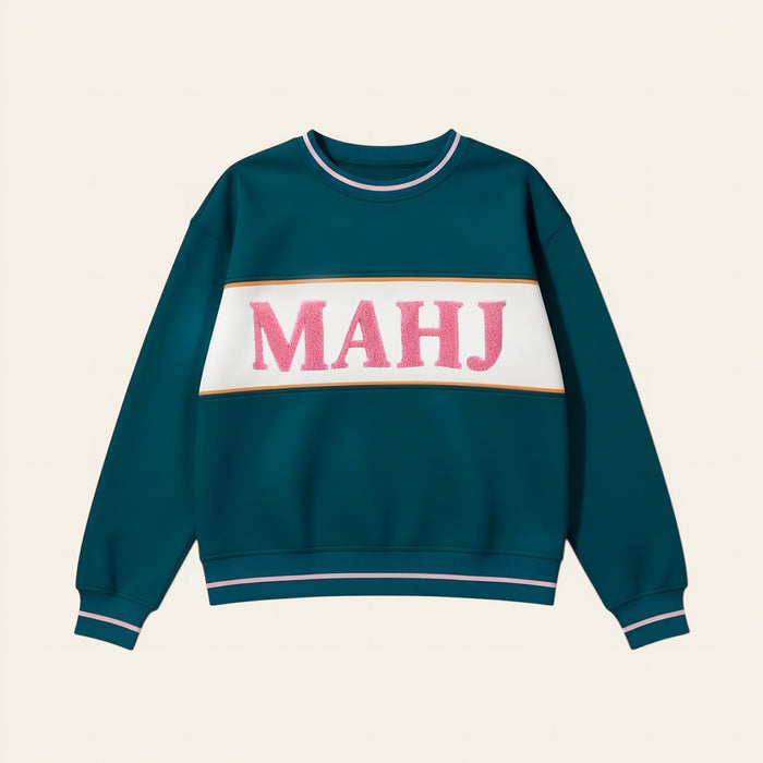 The Darling Effect Mahj Signature Crew features pink textured MAHJ letters on a white stripe with golden-brown borders, plus pink and white striped cuffs and collar for cozy, all-day comfort.