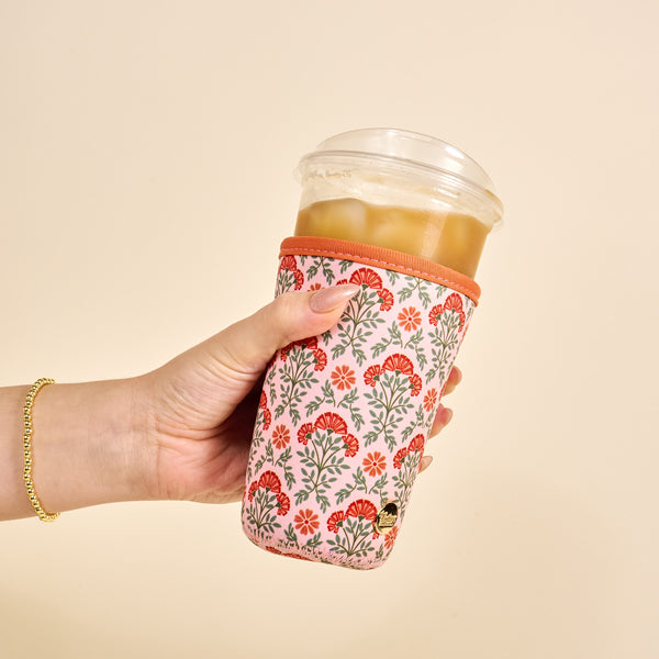 Hand holding an iced coffee in The Darling Effect's Large-Everbloom Dusty Rose Sip Savvy Drink Sleeve.