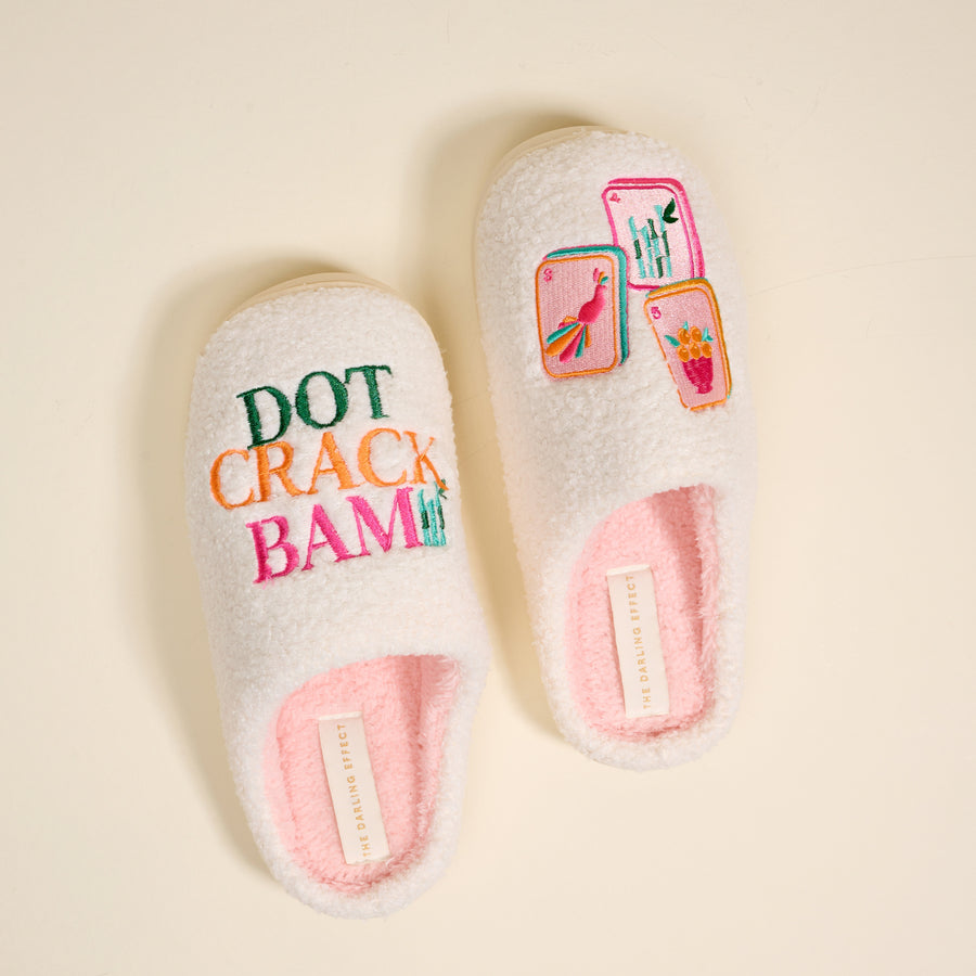 The Darling Effect's Dot Crack Bam Fuzzy Slippers are white with pink trim, featuring "DOT CRACK BAM" and embroidered mahjong tiles for a cozy, playful touch.