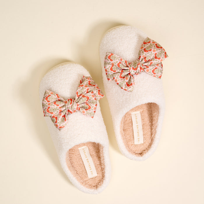 Betty Bow Everbloom Dusty Rose Fuzzy Slippers by The Darling Effect feature cozy white fuzz with pink and red floral bows.