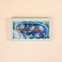The Darling Effect's Endless Daydream Navy Beauty Sleep Mask set includes a navy floral mask and two satin scrunchies, all elegantly packaged in a light blue gift box.