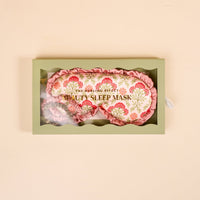 A green box labeled "Everbloom Dusty Rose Beauty Sleep Mask" by The Darling Effect holds a pink floral satin eye mask and matching scrunchie, shown on a light beige background.