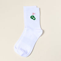 The Darling Effect Golf Embroidered Crew Socks: a white women's sock with a green putting green and pink flag design near the cuff, shown flat on a light beige background—ideal for fans of colorful, embroidered socks.