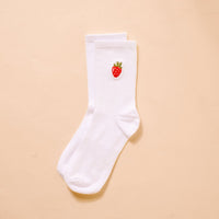 The Darling Effect’s Strawberry Embroidered Crew Socks are white, ribbed women’s socks with a small red strawberry and green leaves stitched near the top—ideal for fans of playful, embroidered socks.
