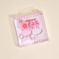 Pink flower and bow silicone straw toppers with pink and white bands, packaged in a clear plastic bag. These leak-resistant straw covers are adorable drinkware accessories for your favorite cups.
