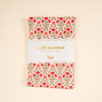 The Darling Effect Everbloom Dusty Rose Waffle Tea Towel features a floral pattern with red and orange flowers and green leaves, displayed flat against a cream background.
