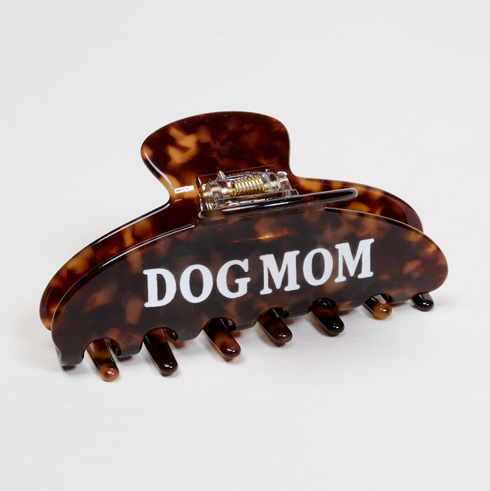 The Darling Effect’s Dog Mom Word Up Claw Clip features a brown tortoiseshell design with “DOG MOM” in white text, making it a bold, playful hair accessory. Shown on a plain white background.